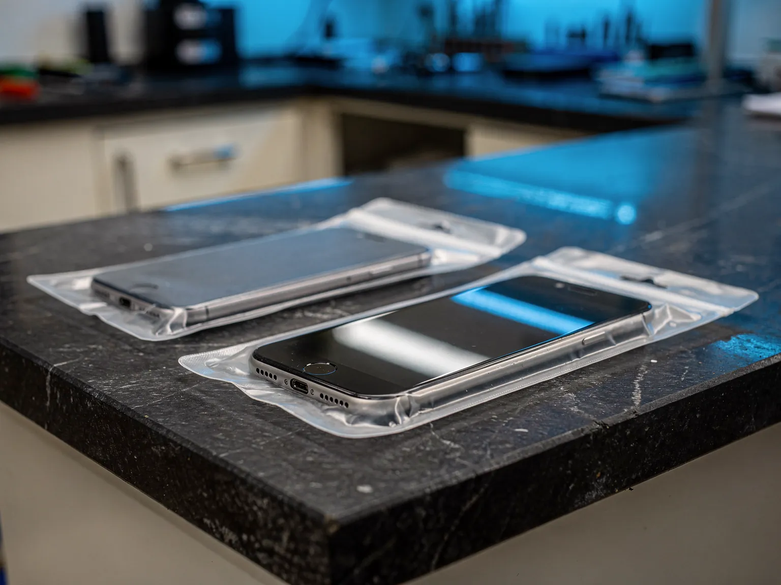 Illustration: sealed phone displays laid out on a spares counter